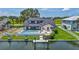 A stunning view of a home with a pool and a dock, backing up to a tranquil body of water at 4506 17Th W St, Palmetto, FL 34221