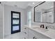 This modern bathroom features a white vanity, quartz counters, and a designer door to match at 4506 17Th W St, Palmetto, FL 34221