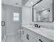 This modern bathroom features a white vanity, quartz counters, and a designer mirror at 4506 17Th W St, Palmetto, FL 34221