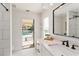 Bright bathroom featuring marble countertop, black fixtures, and a view of the pool at 4506 17Th W St, Palmetto, FL 34221
