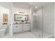 Modern bathroom featuring a walk-in shower, marble counters, and stylish lighting at 4506 17Th W St, Palmetto, FL 34221