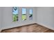 Bedroom with wood floors and large windows, providing plenty of natural light at 4506 17Th W St, Palmetto, FL 34221
