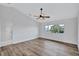 Spacious bedroom with a ceiling fan, wood floors, and a large window showing green vegetation at 4506 17Th W St, Palmetto, FL 34221