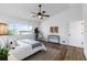 Bright bedroom featuring a ceiling fan, wood floors, and a large window offering views of the outdoors at 4506 17Th W St, Palmetto, FL 34221