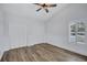 This bedroom boasts modern wainscoting, wood flooring, neutral walls, and double closets at 4506 17Th W St, Palmetto, FL 34221