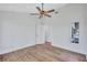 This bedroom has a modern ceiling fan, wood flooring, and neutral walls and trim at 4506 17Th W St, Palmetto, FL 34221
