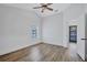 This bedroom features a modern ceiling fan, wood flooring, and wainscoting at 4506 17Th W St, Palmetto, FL 34221