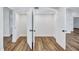 A large, empty walk-in closet featuring modern wood-look flooring and multiple access doors at 4506 17Th W St, Palmetto, FL 34221