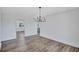 Bright dining area featuring sleek wood floors, modern lighting, and an open layout into other living spaces at 4506 17Th W St, Palmetto, FL 34221