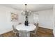 A dining room with a chandelier, modern art, white walls, and a round table with decor at 4506 17Th W St, Palmetto, FL 34221