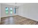 Dining room with wood floors, a modern chandelier, and large windows providing scenic views at 4506 17Th W St, Palmetto, FL 34221
