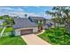 A lovely aerial view of a house featuring a large front yard and a spacious driveway leading to the garage at 4506 17Th W St, Palmetto, FL 34221