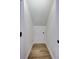 Hallway with wood floor leading to a small storage door with a black knob at 4506 17Th W St, Palmetto, FL 34221