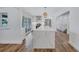 A stylish kitchen showcasing a large island with a waterfall countertop and stainless steel appliances at 4506 17Th W St, Palmetto, FL 34221
