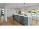 Kitchen showcasing stainless steel appliances, modern cabinetry, an island, and wood flooring at 4506 17Th W St, Palmetto, FL 34221