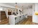 The updated kitchen showcases an expansive island with bar seating, white countertops, and pendant lighting at 4506 17Th W St, Palmetto, FL 34221