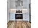 Modern kitchen featuring stainless steel appliances, white cabinetry, and a sleek range hood at 4506 17Th W St, Palmetto, FL 34221