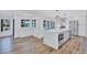 Bright kitchen featuring a large island, pendant lights, stainless steel appliances, and wood flooring at 4506 17Th W St, Palmetto, FL 34221