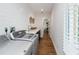 Functional laundry room with modern washer and dryer, shiplap wall, and wood-look floors at 4506 17Th W St, Palmetto, FL 34221