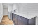 Updated laundry room featuring blue cabinets, white quartz countertop, and a stainless steel washer and dryer at 4506 17Th W St, Palmetto, FL 34221