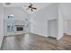 Open living area with light walls, vaulted ceiling, luxury vinyl plank flooring, and cozy fireplace at 4506 17Th W St, Palmetto, FL 34221