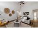 Bright living room with a modern sofa, accent chair, round coffee table, and an area rug at 4506 17Th W St, Palmetto, FL 34221