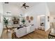 Open-concept living room featuring a cozy fireplace, vaulted ceilings, neutral walls, and modern decor at 4506 17Th W St, Palmetto, FL 34221