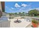Wide angle shot of the outdoor deck with a table overlooking the canal and boat dock at 4506 17Th W St, Palmetto, FL 34221