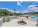 Wide angle shot of the outdoor deck with a table and pool overlooking the canal and boat dock at 4506 17Th W St, Palmetto, FL 34221