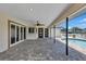Wide angle shot of the patio showing the ceiling fan and view of the pool at 4506 17Th W St, Palmetto, FL 34221