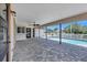 Wide angle shot of the patio showing the ceiling fan and view of the pool at 4506 17Th W St, Palmetto, FL 34221