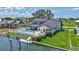 Charming waterfront home featuring a private pool, boat dock, and manicured lawn at 4506 17Th W St, Palmetto, FL 34221