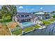 Waterfront home featuring a private pool, boat dock, fenced yard, and tropical landscaping at 4506 17Th W St, Palmetto, FL 34221