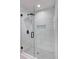 Modern walk-in shower featuring elegant white tiling and sleek black hardware at 4506 17Th W St, Palmetto, FL 34221