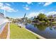 Beautiful waterfront property with a well-maintained lawn, dock, and lift, perfect for boating at 4506 17Th W St, Palmetto, FL 34221
