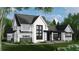 Charming two-story white home with black accents, stone detail, professional landscaping, and a covered entryway at 4704 Riverwood Ave, Sarasota, FL 34231