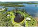Stunning aerial view showcasing tranquil lake, winding path, and waterfront property with mature trees at 4736 Independence Dr # 4736, Bradenton, FL 34210