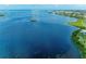 Beautiful aerial view of the calm, blue waters with a small island and waterfront property at 4736 Independence Dr # 4736, Bradenton, FL 34210