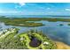 Scenic aerial view of waterfront property with lake, winding trails, and lush landscaping at 4736 Independence Dr # 4736, Bradenton, FL 34210