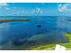 Expansive aerial view of the bay with blue waters and distant islands under sunny skies at 4736 Independence Dr # 4736, Bradenton, FL 34210