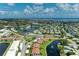 Beautiful aerial view featuring waterfront community, tennis court, and a shimmering lake at 4736 Independence Dr # 4736, Bradenton, FL 34210