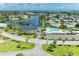 Attractive aerial shot of the community pool, clubhouse, and nearby pond in a well-maintained community at 4736 Independence Dr # 4736, Bradenton, FL 34210