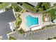 Aerial view of the large, bright blue community pool with lounge chairs and lush landscaping at 4736 Independence Dr # 4736, Bradenton, FL 34210