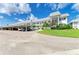Condominium exterior with parking, landscaping, and a white facade providing curb appeal at 4736 Independence Dr # 4736, Bradenton, FL 34210