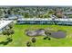 Beautifully landscaped waterfront condo building with a pond and fountain feature in the manicured lawn at 4736 Independence Dr # 4736, Bradenton, FL 34210