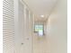 Bright hallway features tile flooring, built-in cabinets, and beach view beyond the living room at 4736 Independence Dr # 4736, Bradenton, FL 34210