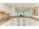 Open kitchen features granite countertops, breakfast bar and view to adjacent dining room at 4736 Independence Dr # 4736, Bradenton, FL 34210