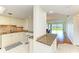 Well-lit kitchen with granite countertop, breakfast bar and adjacent views to dining and living room at 4736 Independence Dr # 4736, Bradenton, FL 34210