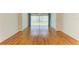 Minimalist living room featuring hardwood floors, a ceiling fan, and a large window with blinds at 4736 Independence Dr # 4736, Bradenton, FL 34210
