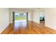 Spacious living room with wood floors and views of the backyard from the sliding glass doors at 4736 Independence Dr # 4736, Bradenton, FL 34210